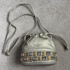 The Icing Metallic Gold Drawstring Bucket Bag with Gold & Silver Accent